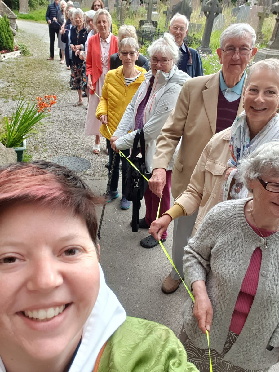 Clypping service - people holding hands around the church