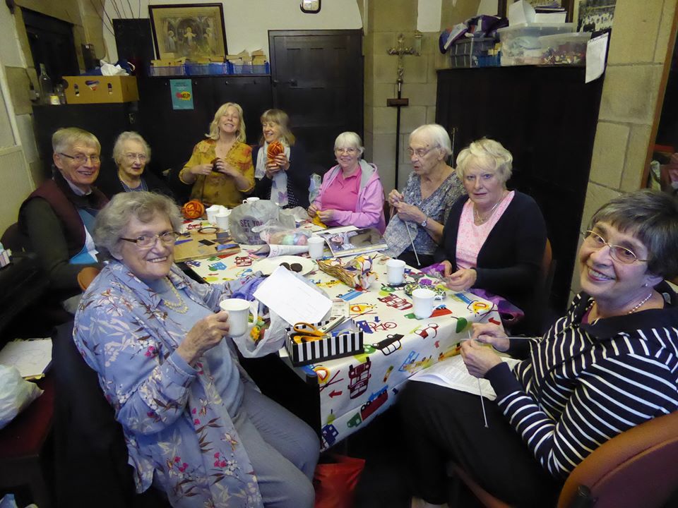 People doing craft around a table